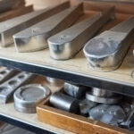 New steel parts on shelf. Metal parts in workshop.