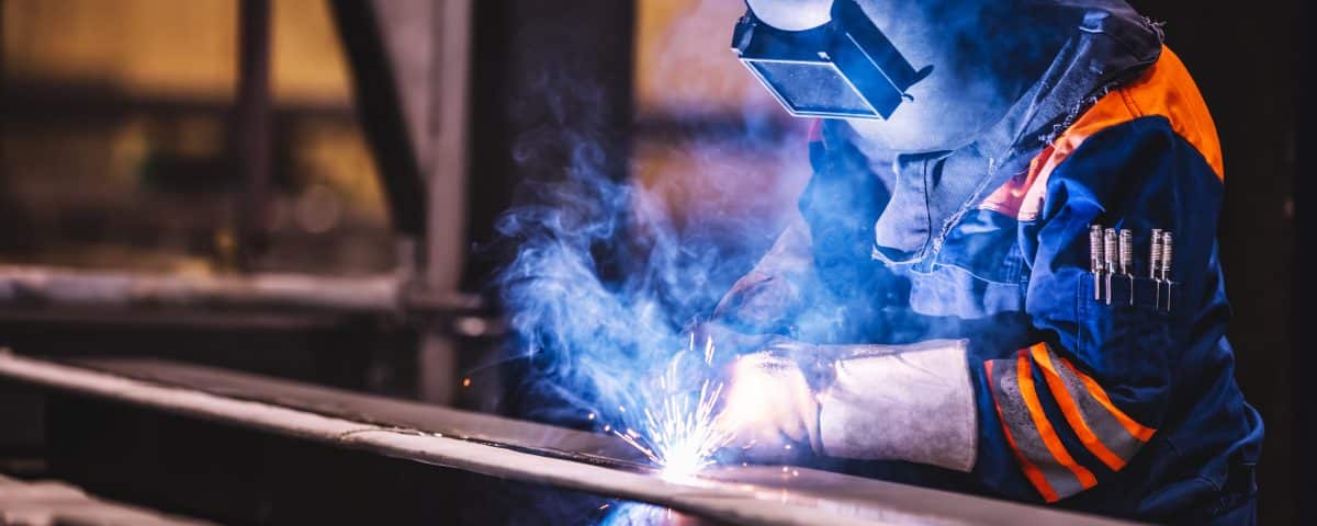 Worker welding in a factory. Heavy industry, welder work