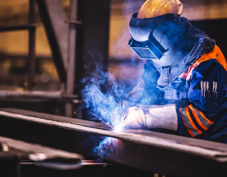 Worker welding in a factory. Heavy industry, welder work