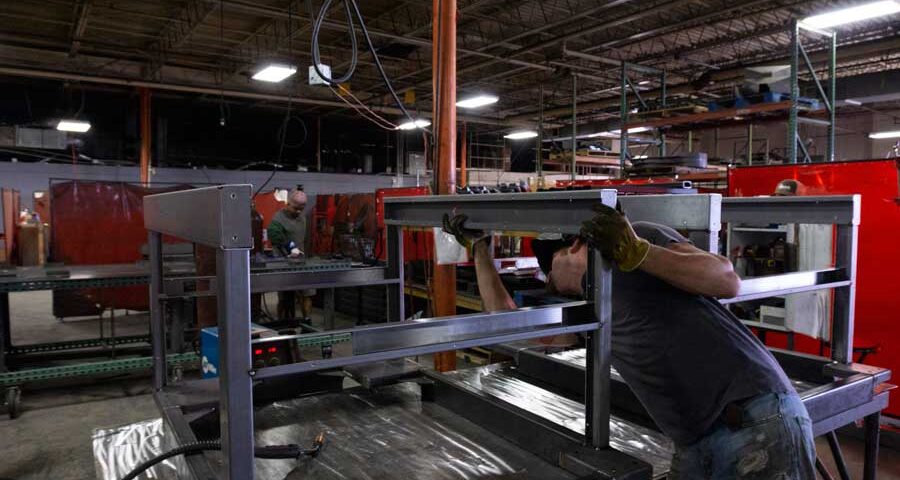 Quality control check: man assessing metal product