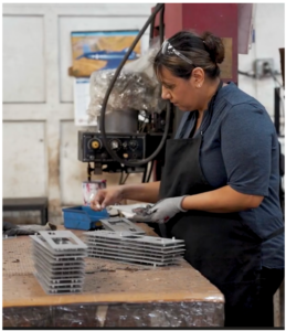 ams woman employee conducting quality assurance on cnc machine