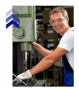 Technician operating industrial drill press in a metal shop, showcasing hands-on fabrication for engineers