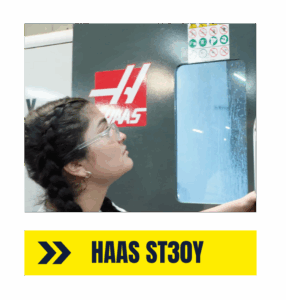 Operating the HAAS ST30Y CNC Turning Center at AMS - Accurate Metal Stamping technician monitoring HAAS ST30Y CNC lathe for cylindrical precision
