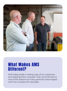 - Accurate Metal Stamping AMS team members discussing production needs with manufacturing partners near industrial equipment.